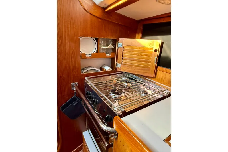 Slide: The Image of Wooden yacht galley with stove and storage, J/Boats J/47, 1991 model. - 9