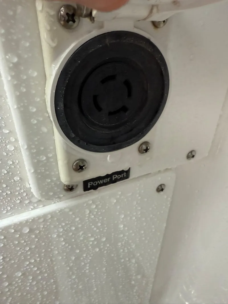 Slide: The Image of Power port on 2023 Everglades 285 Center Console, wet surface, close-up view. - 14