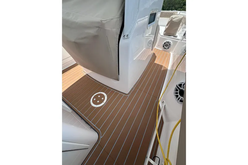 Slide: The Image of 2023 Everglades 285 Center Console boat deck with teak flooring and covered console. - 17