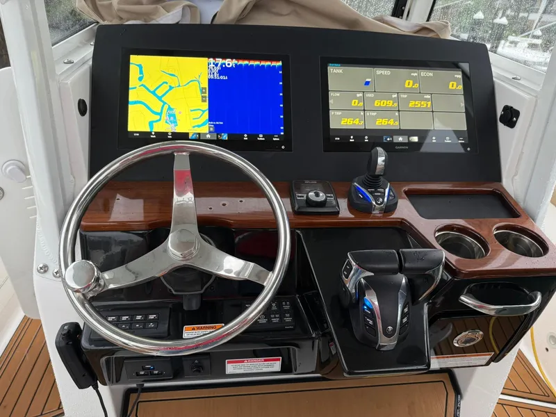 Slide: The Image of 2023 Everglades 285 Center Console dashboard with navigation screens and controls. - 5