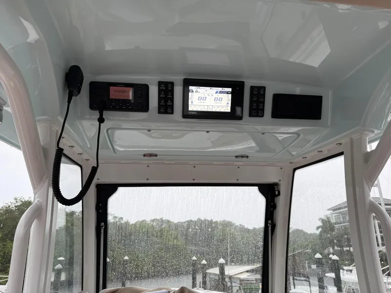 Slide: The Image of 2023 Everglades 285 Center Console boat dashboard with navigation and communication equipment. - 6