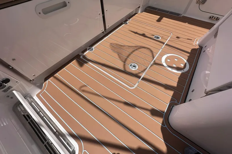 Slide: The Image of 2023 Everglades 285 Center Console boat deck with sleek, modern design and durable flooring. - 9