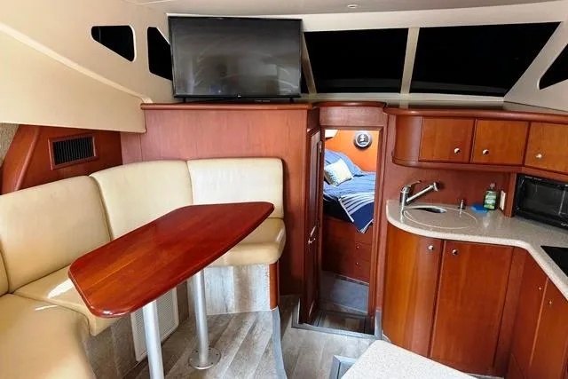 Slide: The Image of Interior of 2004 Silverton 35 MY Aft Cabin Motoryacht with dining area and kitchenette. - 12