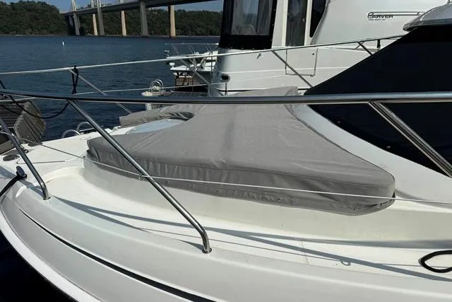 Slide: The Image of 2004 Silverton 35 MY Aft Cabin Motoryacht on water, featuring sleek design and covered deck. - 13