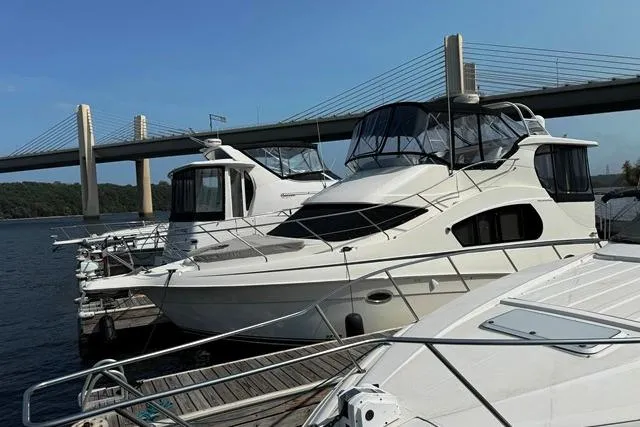 Slide: The Image of 2004 Silverton 35 MY Aft Cabin Motoryacht docked near a bridge. - 14