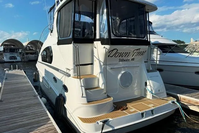 Slide: The Image of 2004 Silverton 35 MY Aft Cabin Motoryacht docked, featuring "Down Time" name. - 18