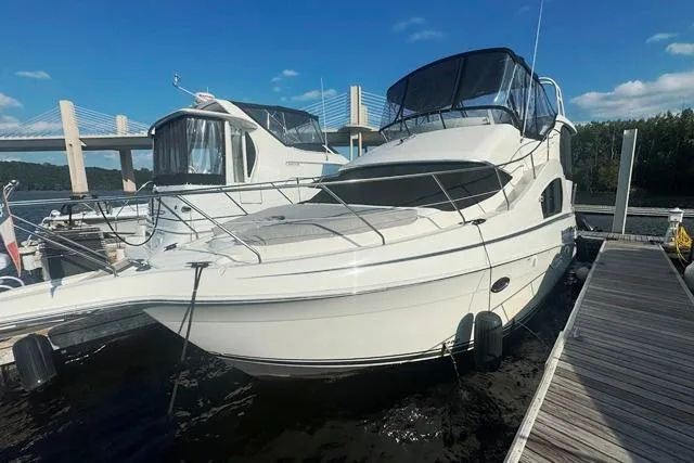 Slide: The Image of 2004 Silverton 35 MY Aft Cabin Motoryacht docked at marina under clear sky. - 2