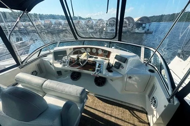 Slide: The Image of 2004 Silverton 35 MY Aft Cabin Motoryacht helm with marina view. - 20