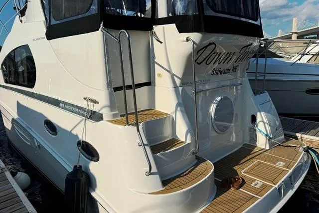 Slide: The Image of 2004 Silverton 35 MY Aft Cabin Motoryacht docked, featuring elegant design and spacious deck. - 24