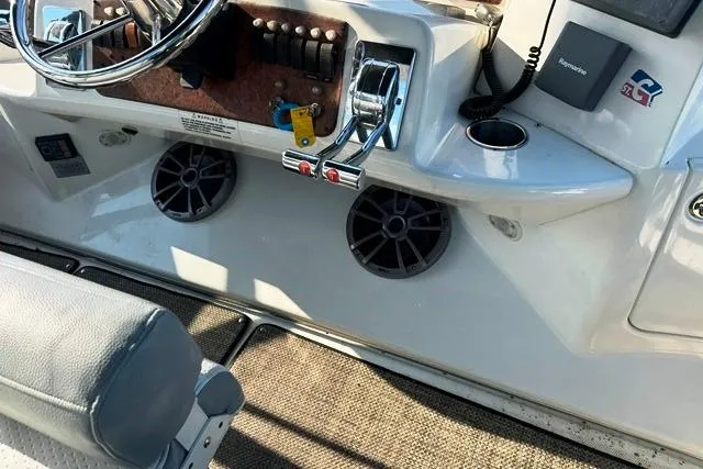 Slide: The Image of 2004 Silverton 35 MY Aft Cabin Motoryacht helm with controls and speakers. - 27