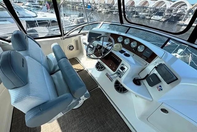 Slide: The Image of 2004 Silverton 35 MY Aft Cabin Motoryacht helm with steering wheel and navigation instruments. - 31