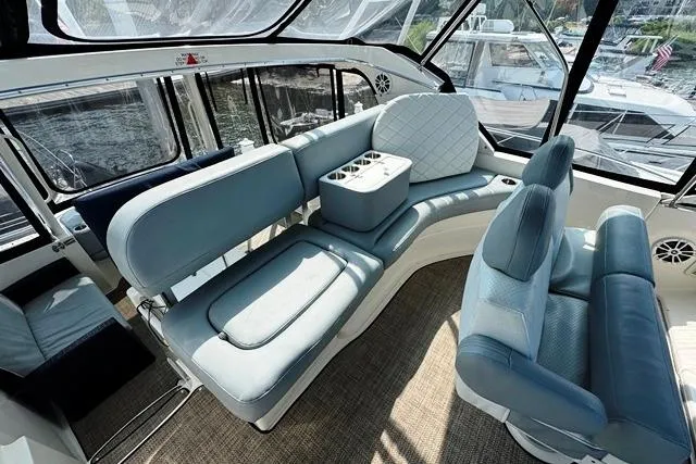 Slide: The Image of 2004 Silverton 35 MY Aft Cabin Motoryacht interior with blue seating and panoramic windows. - 32