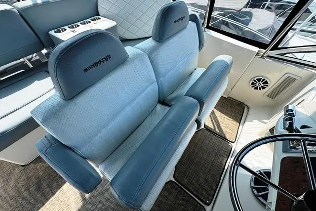 Slide: The Image of 2004 Silverton 35 MY Aft Cabin Motoryacht interior with plush seating and steering wheel. - 34