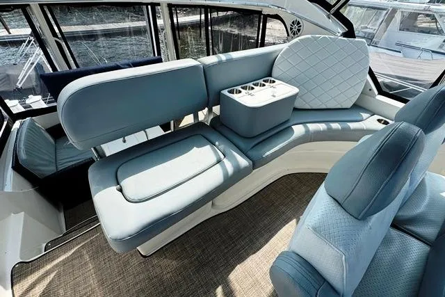 Slide: The Image of 2004 Silverton 35 MY Aft Cabin Motoryacht interior with blue seating and cup holders. - 35