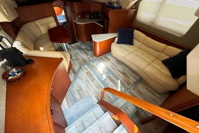 Slide: The Image of 2004 Silverton 35 MY Aft Cabin Motoryacht interior with plush seating and wooden accents. - 36
