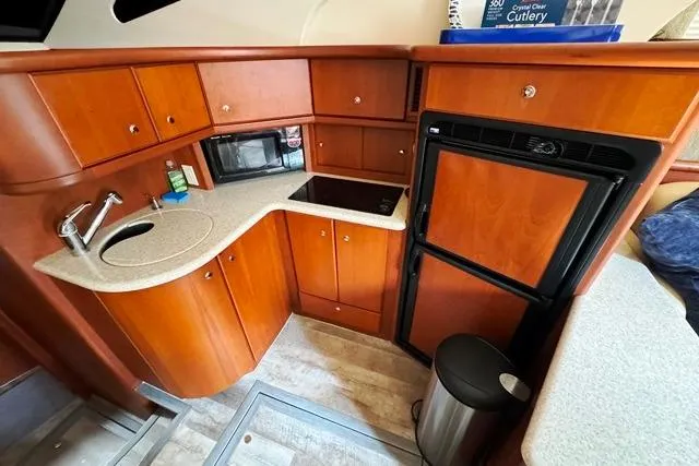 Slide: The Image of 2004 Silverton 35 MY Aft Cabin Motoryacht kitchen with wood cabinetry and modern appliances. - 39