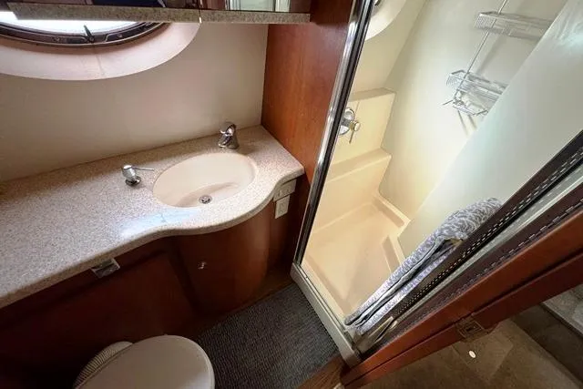 Slide: The Image of 2004 Silverton 35 MY Aft Cabin Motoryacht bathroom with sink, shower, and toilet. - 4