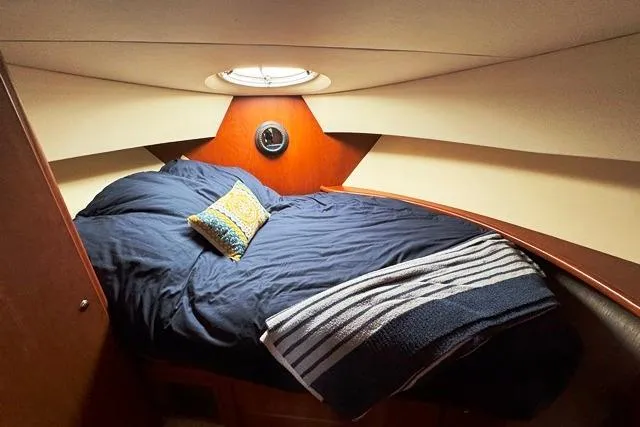 Slide: The Image of 2004 Silverton 35 MY Aft Cabin Motoryacht bedroom with cozy bedding and porthole window. - 40