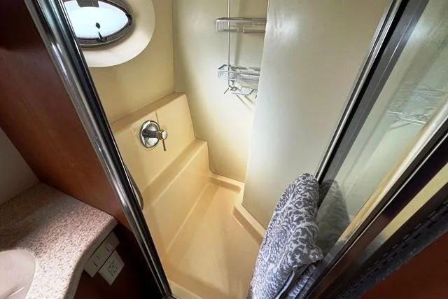 Slide: The Image of 2004 Silverton 35 MY Aft Cabin Motoryacht shower with porthole and towel rack. - 5