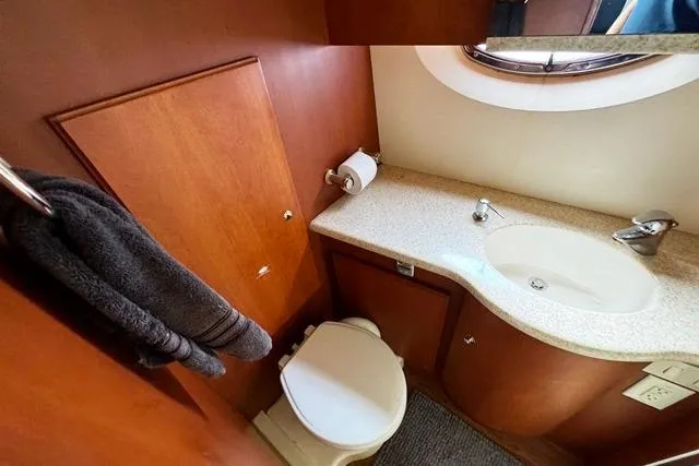 Slide: The Image of 2004 Silverton 35 MY Aft Cabin Motoryacht bathroom with sink, toilet, and towel rack. - 6