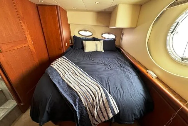 Slide: The Image of 2004 Silverton 35 MY Aft Cabin Motoryacht bedroom with cozy bed and porthole windows. - 7