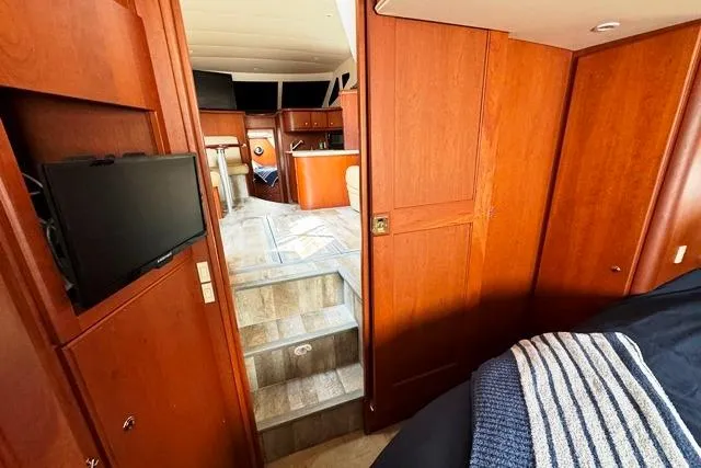 Slide: The Image of Interior of 2004 Silverton 35 MY Aft Cabin Motoryacht with wood paneling and modern amenities. - 8