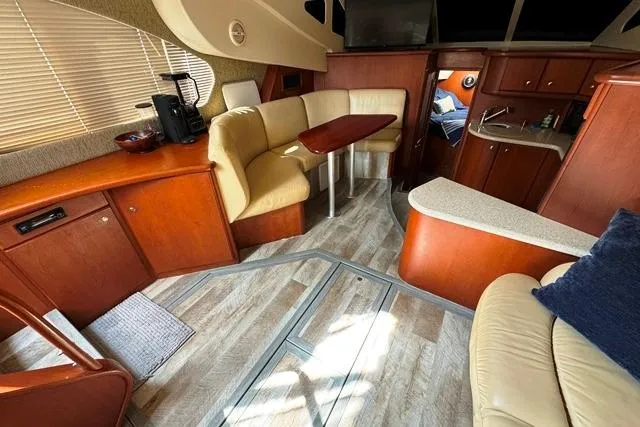 Slide: The Image of 2004 Silverton 35 MY Aft Cabin Motoryacht interior with wood cabinetry and seating area. - 9