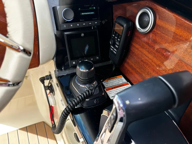 Slide: The Image of 2023 Chris-Craft Launch 31 GT dashboard with controls and wood paneling. - 11
