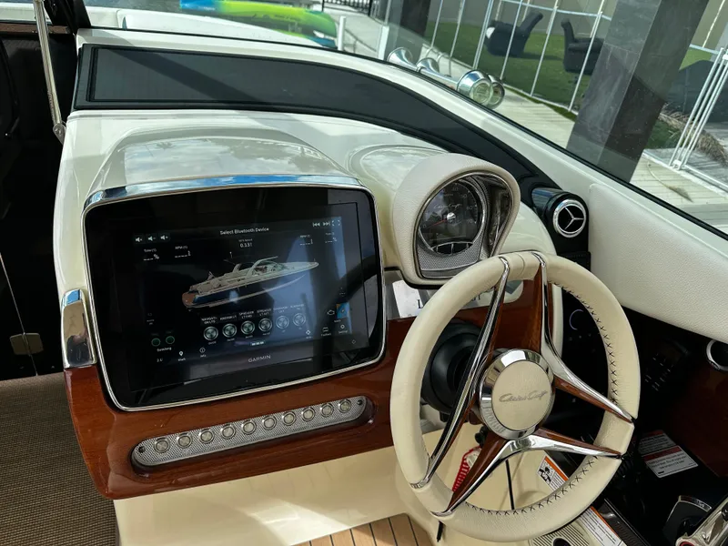 Slide: The Image of 2023 Chris-Craft Launch 31 GT dashboard with steering wheel and digital display. - 12