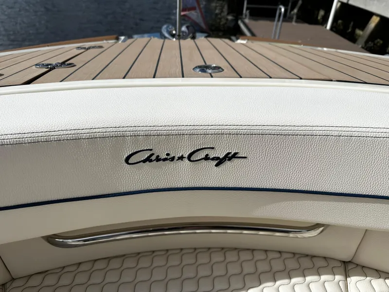 Slide: The Image of 2023 Chris-Craft Launch 31 GT boat interior with logo and wooden deck. - 16