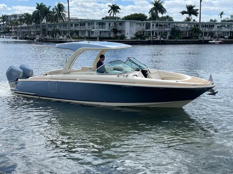 Slide: The Image of 2023 Chris-Craft Launch 31 GT boat cruising on a sunny waterfront. - 3