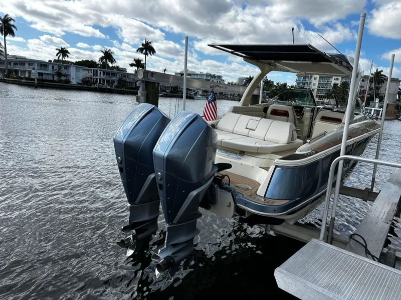 Slide: The Image of 2023 Chris-Craft Launch 31 GT boat docked with twin engines, scenic waterfront view. - 5