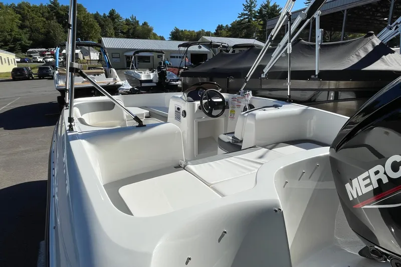 Slide: The Image of 2026 Bayliner Element E16 boat with Mercury engine, parked outdoors. - 7