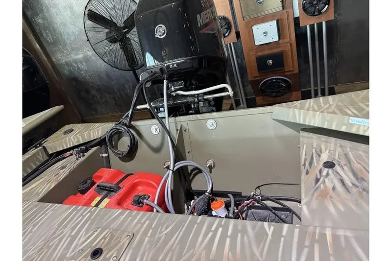 Slide: The Image of 2024 Tracker Grizzly 1648 boat interior with engine and wiring details. - 7