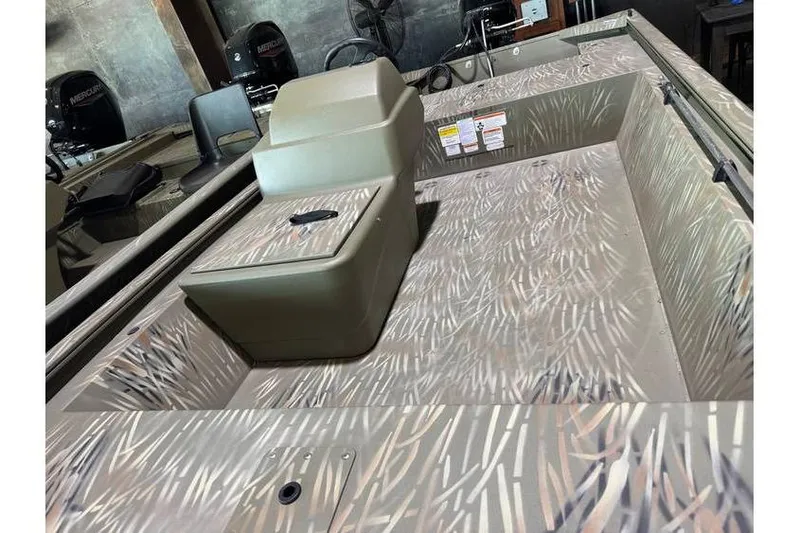 Slide: The Image of 2024 Tracker Grizzly 1648 boat interior with camouflage pattern and seating. - 9