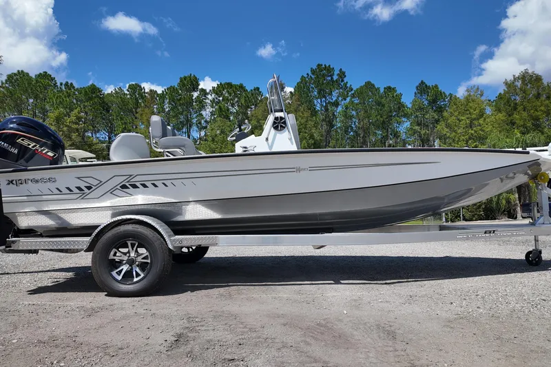 The Image of 2026 Xpress H20 boat on trailer, sleek design, Yamaha engine, outdoor setting. - 0
