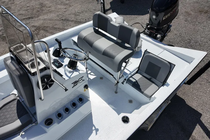 Slide: The Image of 2026 Xpress H20 boat interior with steering console, seating, and motor. - 14