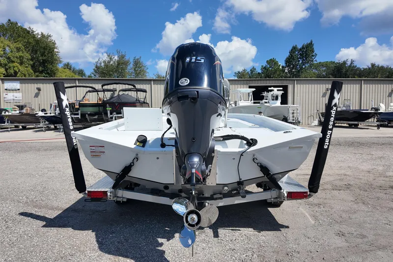 Slide: The Image of 2026 Xpress H20 boat with powerful outboard motor, parked outdoors under a clear sky. - 16
