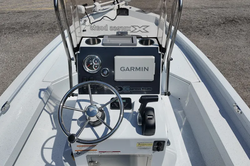 Slide: The Image of Xpress H20 boat dashboard with Garmin system, steering wheel, and controls, 2026 model. - 18