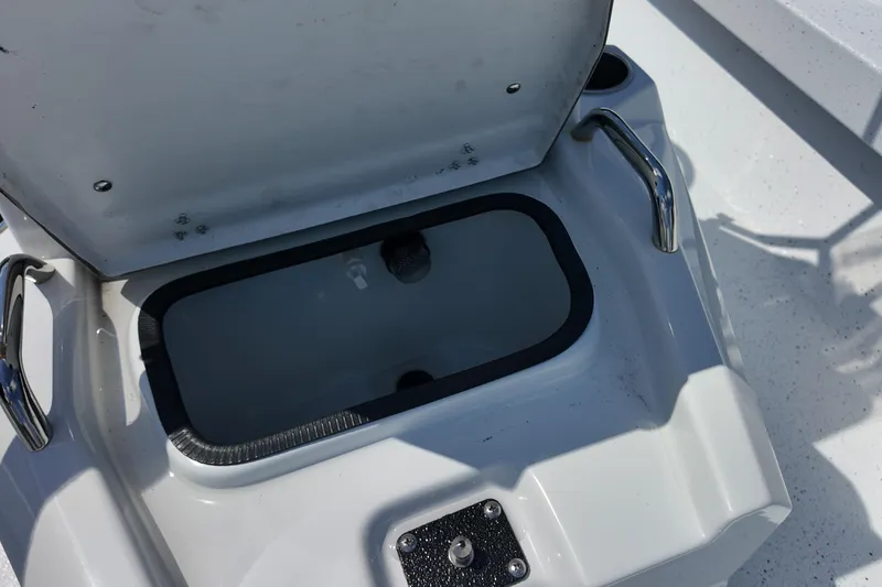 Slide: The Image of Open storage compartment on 2026 Xpress H20 boat, featuring stainless steel handles. - 19