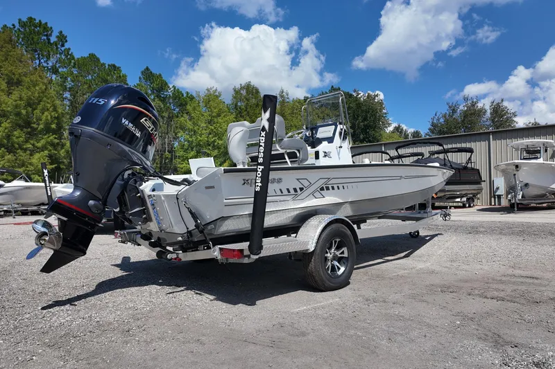 Slide: The Image of 2026 Xpress H20 boat with Yamaha motor on trailer, parked outdoors. - 2
