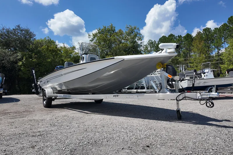 Slide: The Image of 2026 Xpress H20 boat on trailer under blue sky with clouds. - 4