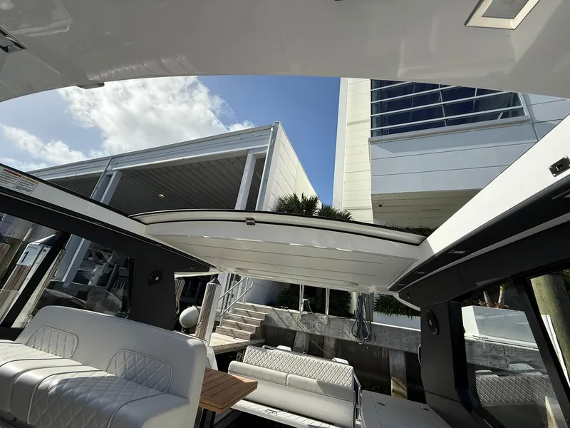 Slide: The Image of Interior view of 2025 Schaefer 375 yacht with open roof and modern seating. - 14