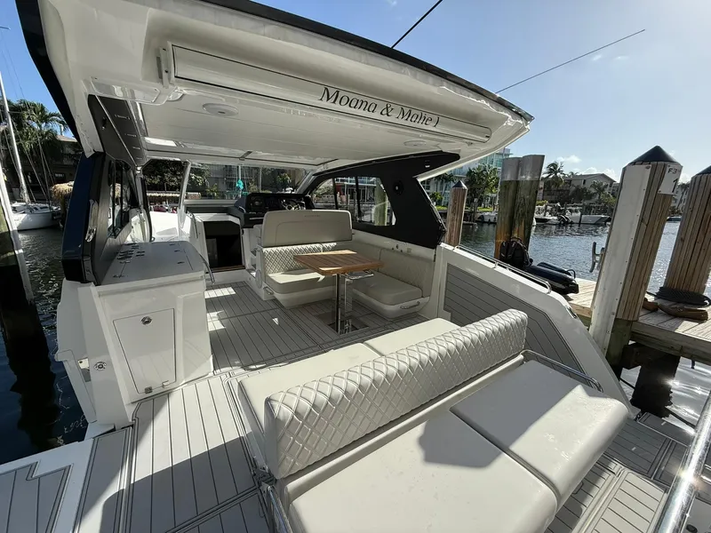 Slide: The Image of Luxurious 2025 Schaefer 375 yacht interior with elegant seating and dining area at a marina. - 15