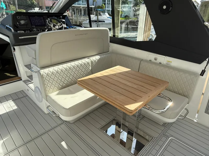 Slide: The Image of Luxurious 2025 Schaefer 375 yacht interior with elegant seating and wooden table. - 16
