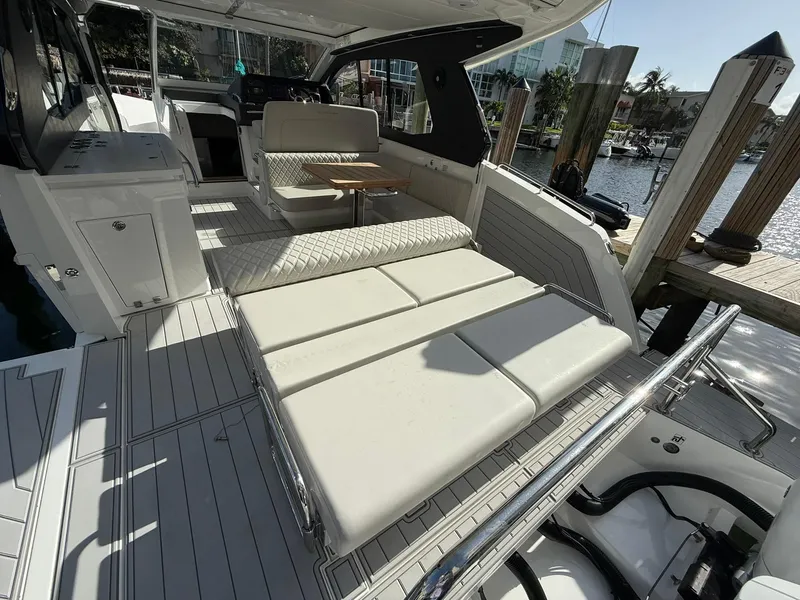 Slide: The Image of 2025 Schaefer 375 yacht interior with luxurious seating and modern design at a marina. - 19