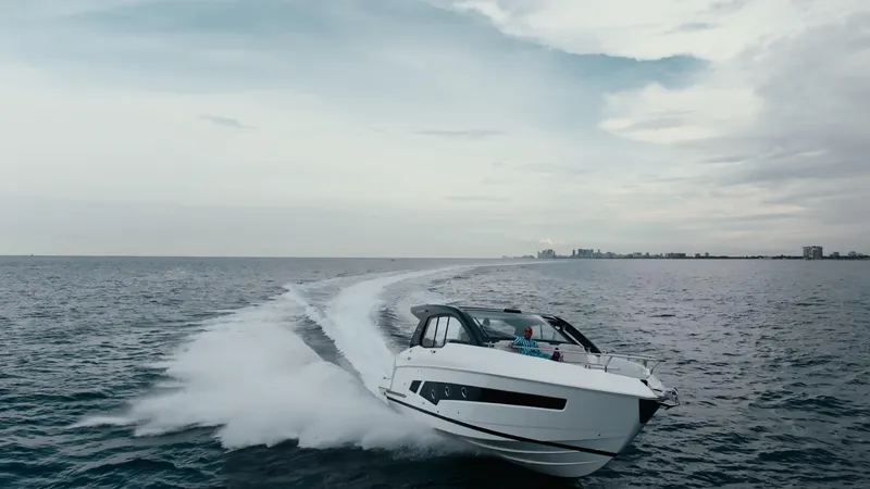 Slide: The Image of 2025 Schaefer 375 yacht cruising on open sea under cloudy sky. - 2