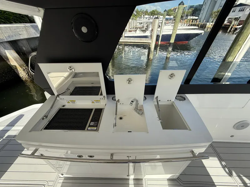 Slide: The Image of Luxury Schaefer 375 yacht kitchen area with sink and grill, docked at marina, 2025 model. - 24
