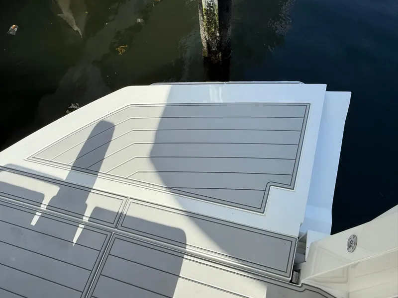 Slide: The Image of Schaefer 375 boat deck, 2025 model, with sleek design and water reflection. - 26
