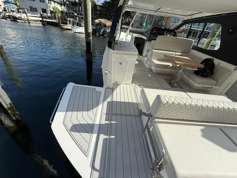 Slide: The Image of 2025 Schaefer 375 yacht interior with elegant seating and waterfront view. - 27